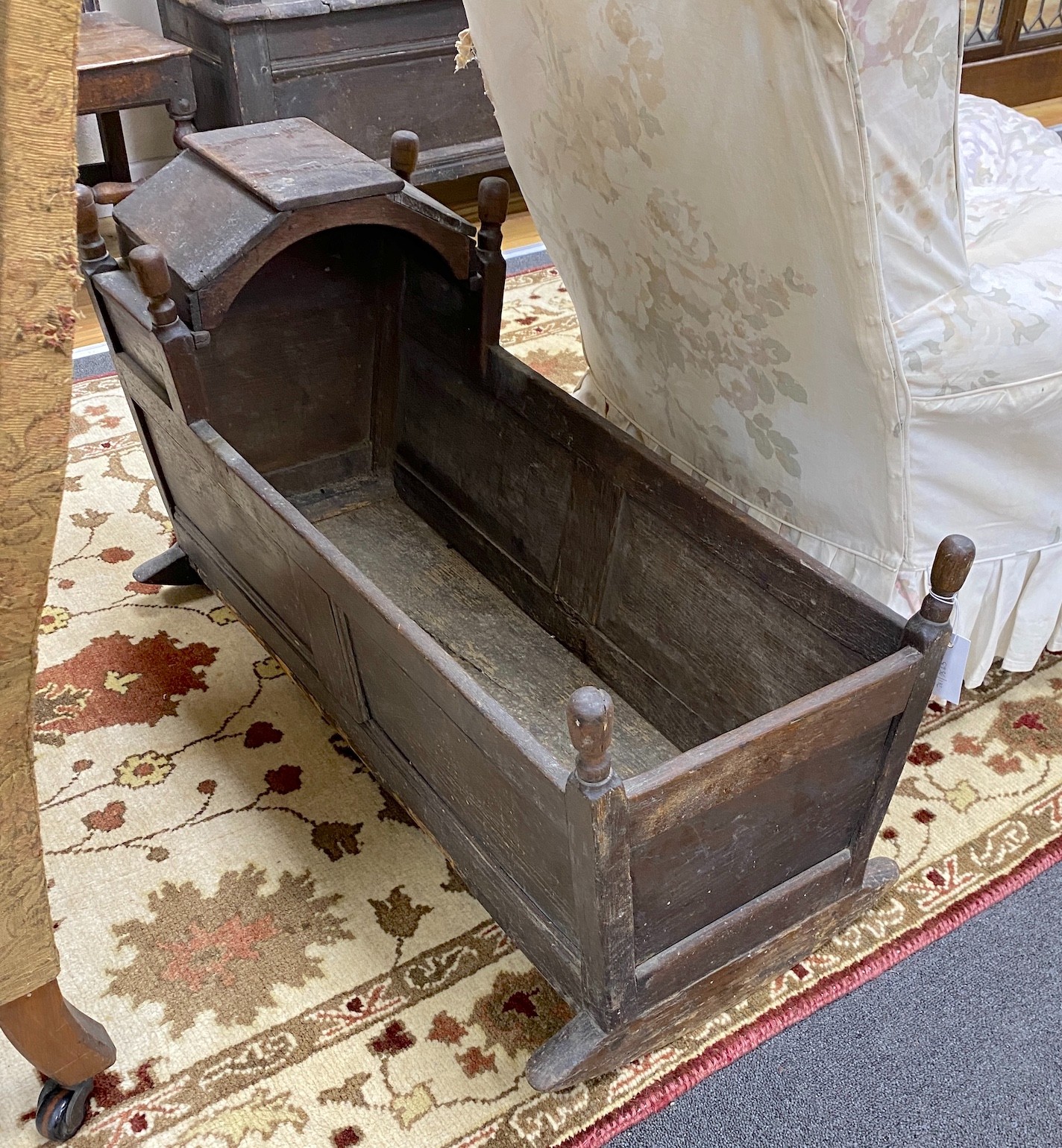 An 18th century oak rocking cradle, with hinged canopy, length 92cm, width 38cm, height 56cm